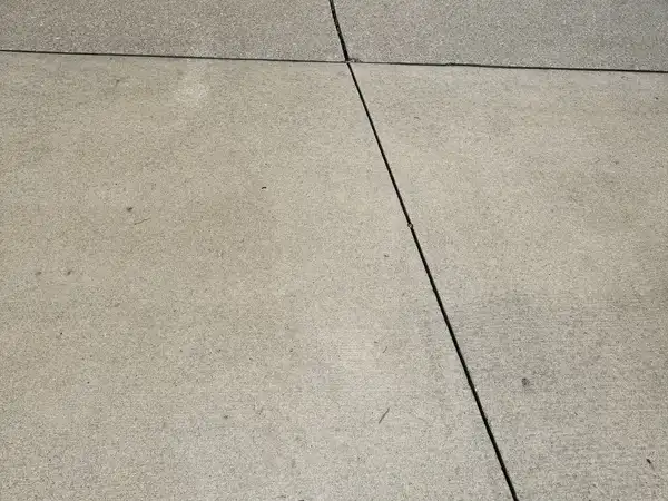 The same Fort Wayne driveway after surface cleaning, lighter and clear of debris