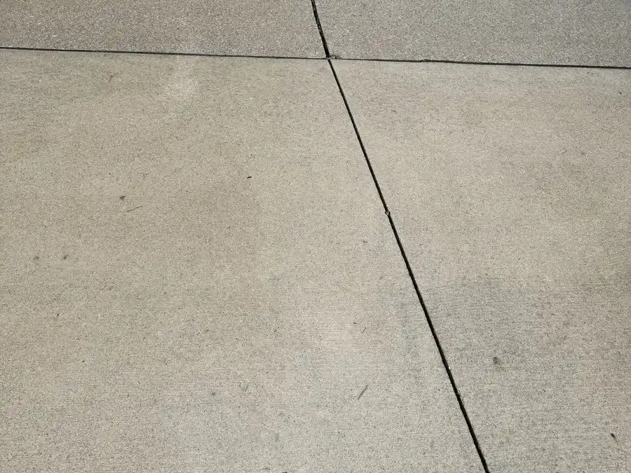 After surface cleaning: the same driveway slabs, lighter and clear of debris