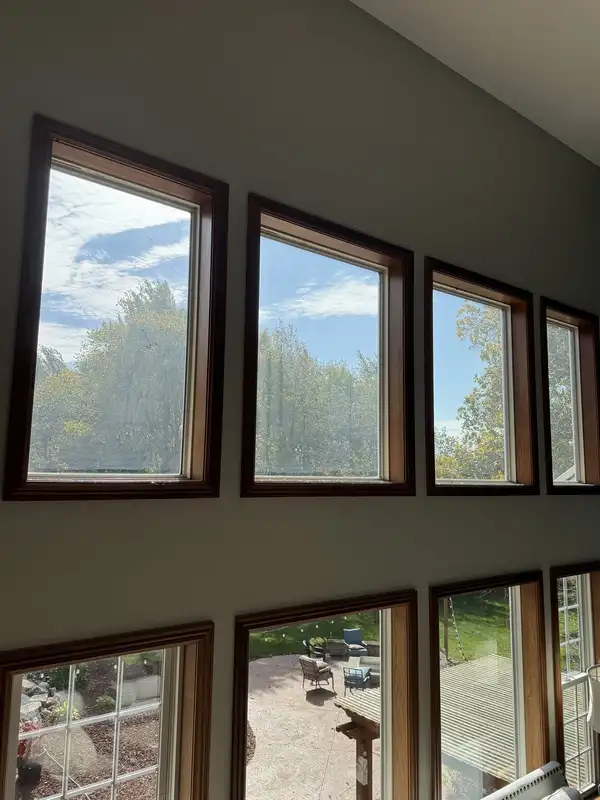 Two rows of tall great-room windows in a Huntertown home, glass clear and bright