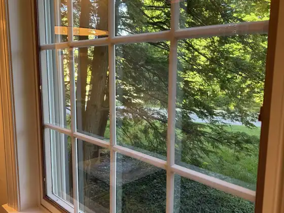 After window cleaning: the same divided-light window with clear glass and no spots