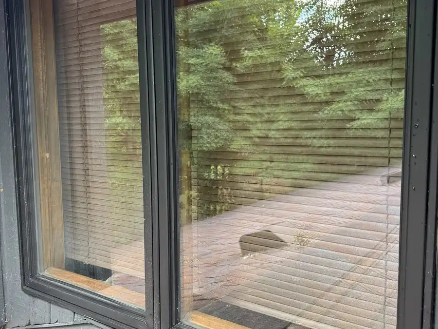 After window cleaning: the same picture window with clear, bright glass and clean frames
